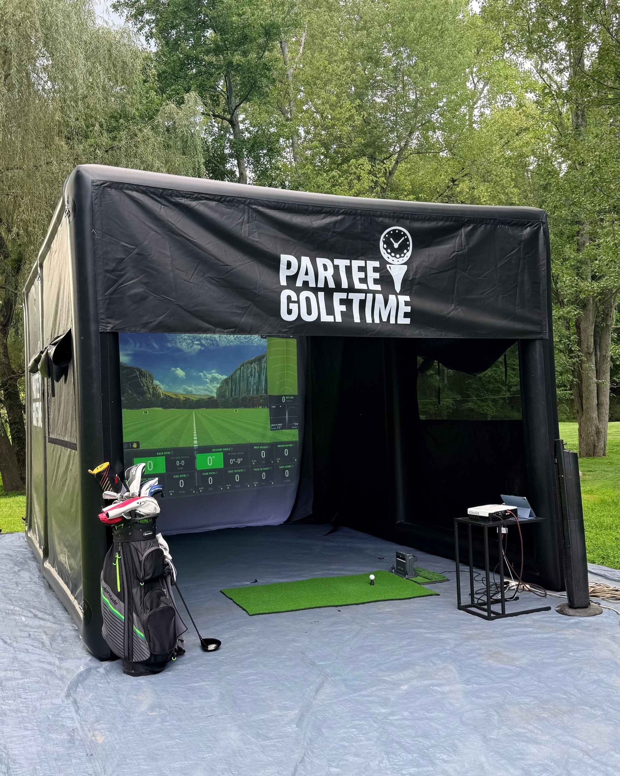 PARTEEGOLFTIME mobile golf simulator booth set up outdoors